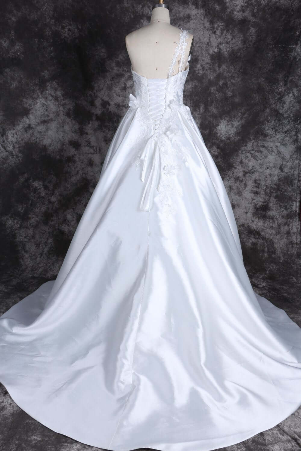 Wedding dress with floral appliqué and long train